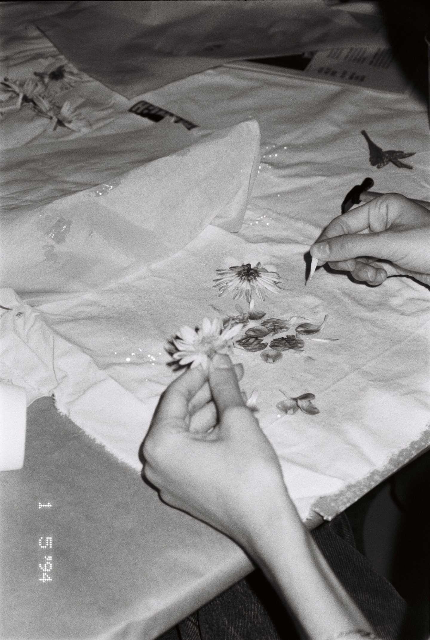 Close-up of hands working on handicrafts. Photograph.