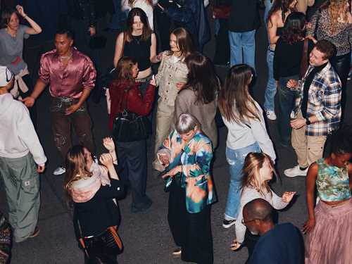 A full dance floor seen from above. Photograph.