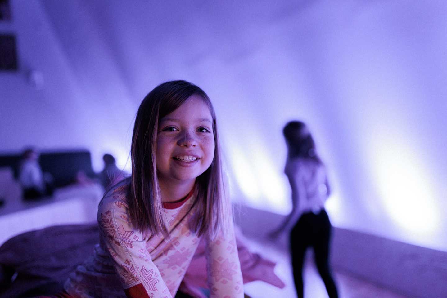 Kids playing in The Chamber of Chaos, a wonderful world of portals, colourful pillows and textile figures, surrounded by magical lighting