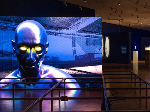 A section of the exhibition hall for MUNCH Triennale – Almost Unreal, showing six of the works on display. Photograph.