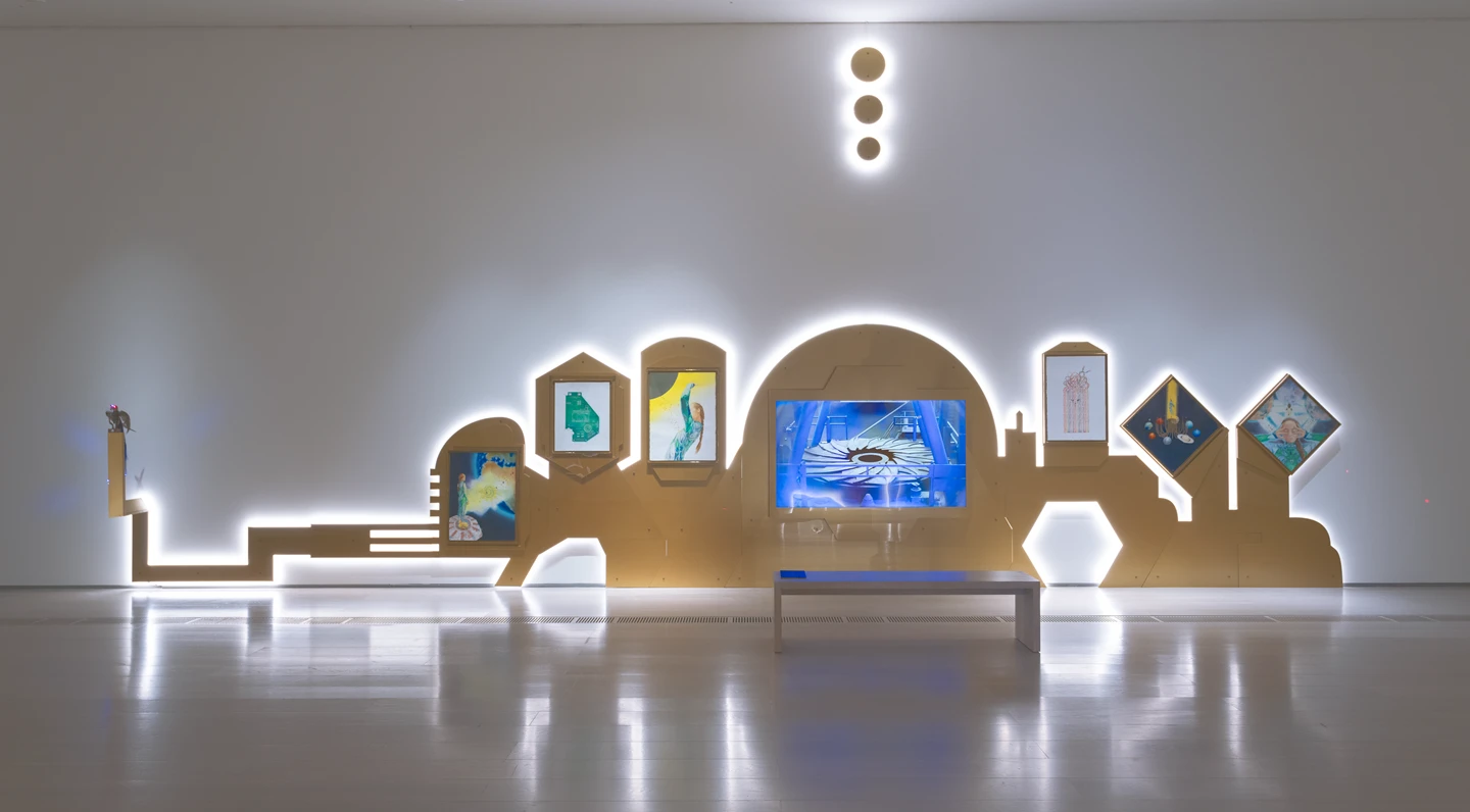 Installation featuring a sculpture of a bird and a series of watercolours hung on a cut-out display. Photograph.