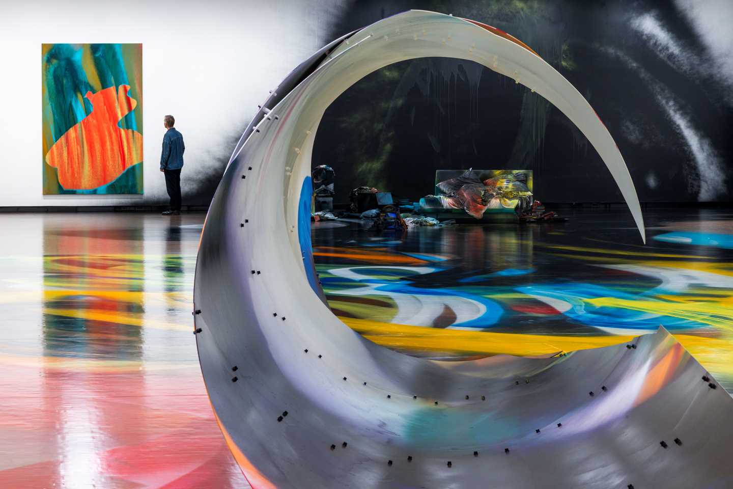 Two installation works by Katharina Grosse, Locke and Black Bed, displayed in the same gallery space. Photograph.