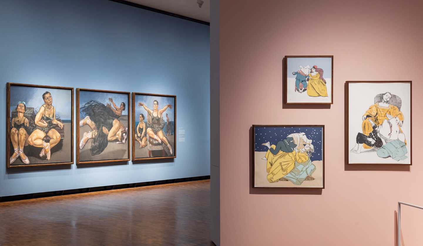 Three works depicting ballet dancers hang on a light blue wall in the rear of the image. In the foreground, three smaller pastels in softer tones hang against a powder pink wall. Photograph.