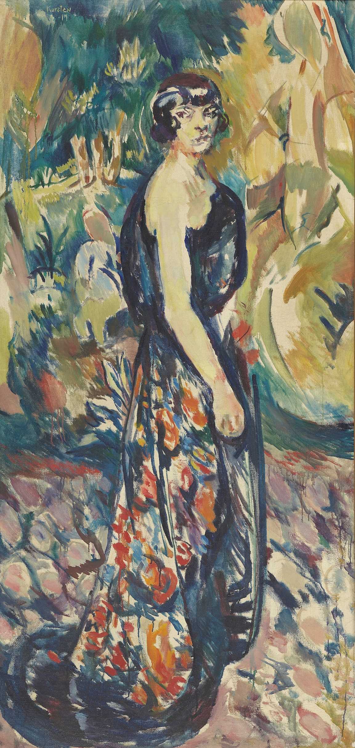 Asta Nielsen stands in profile but turns her head towards us. She is wearing a floor-length dress fastened only over the shoulder furthest from us. In the background are trees and bushes. Painting.