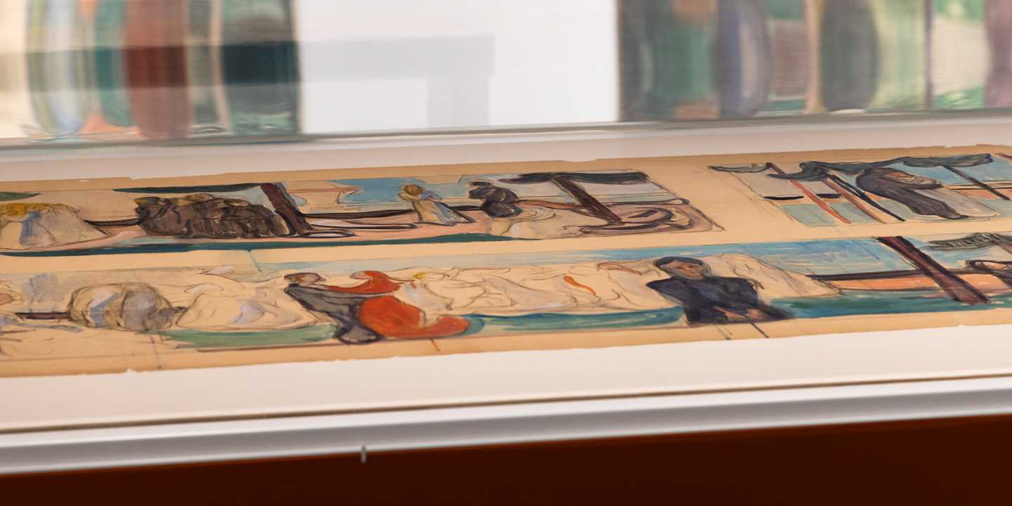 Close-up of a glass display case containing sketches for the Freia Frieze. Photograph.