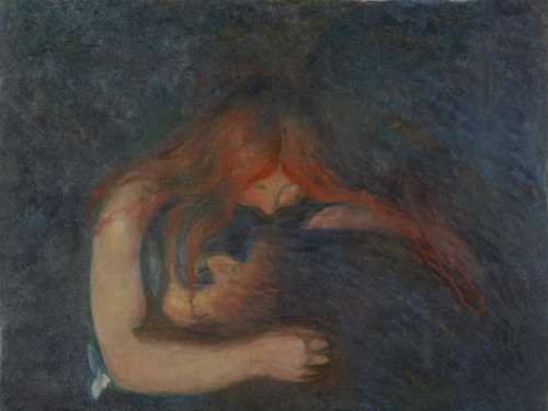 A man buries his head in a woman’s lap. She embraces him, placing her mouth on the back of his neck. Her blood-red hair is draped around the man’s body. The room around them is dark.